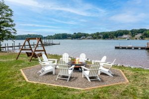 Sun-kissed backyard with fire pit and lake view