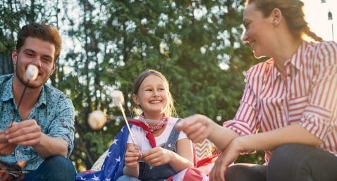 Family Bonfire Night with the American Flag and Marshmallows