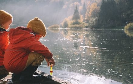 kids by lake in winter coats