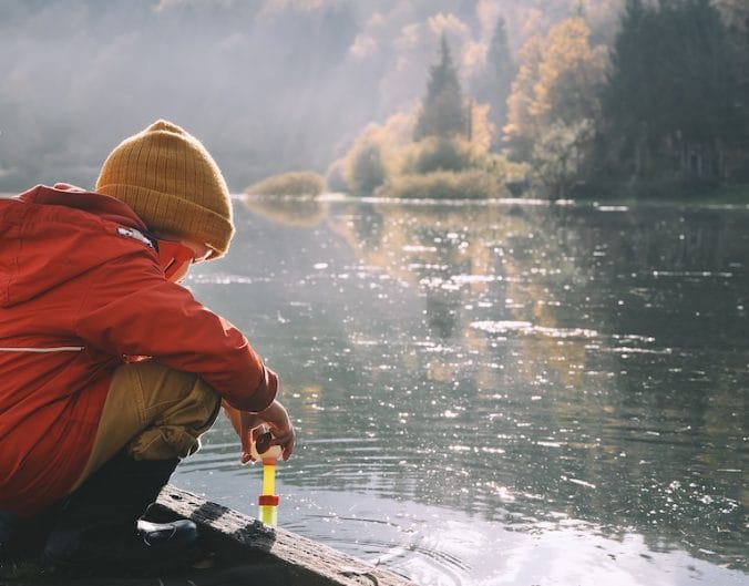 kids by lake in winter coats