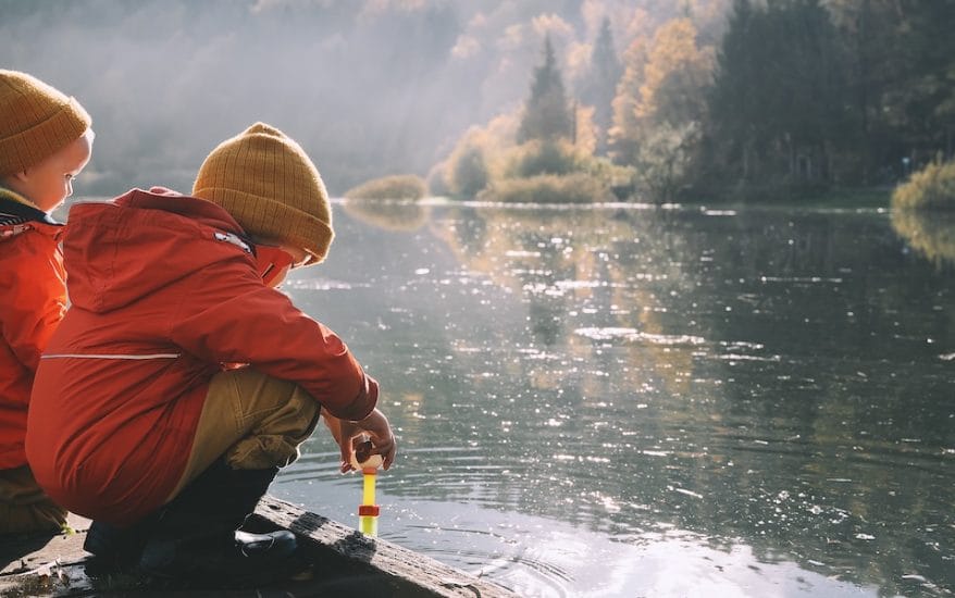 kids by lake in winter coats