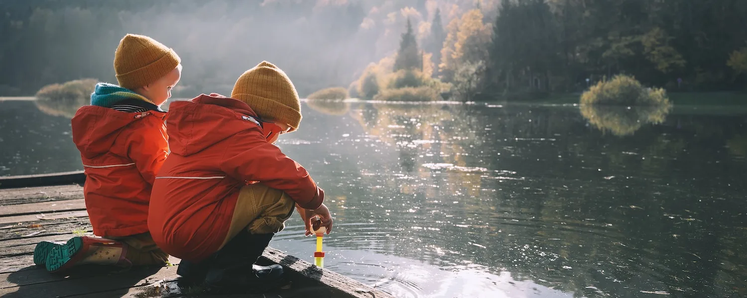 kids by lake in winter coats