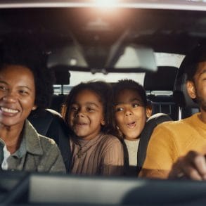 family on a road trip in a car