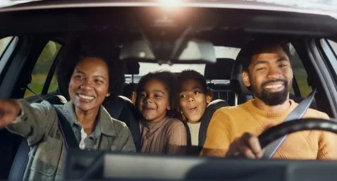 family on a road trip in a car