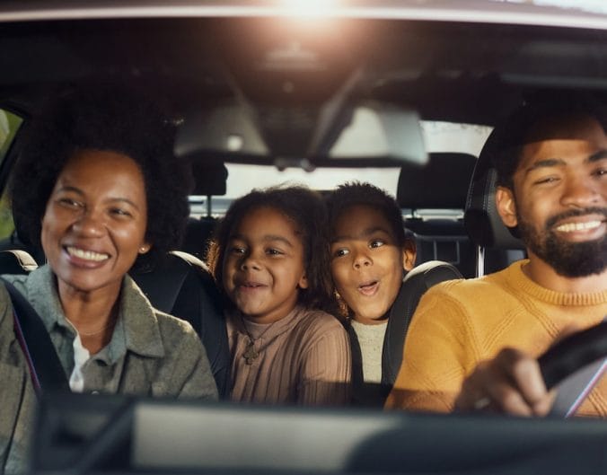 family on a road trip in a car